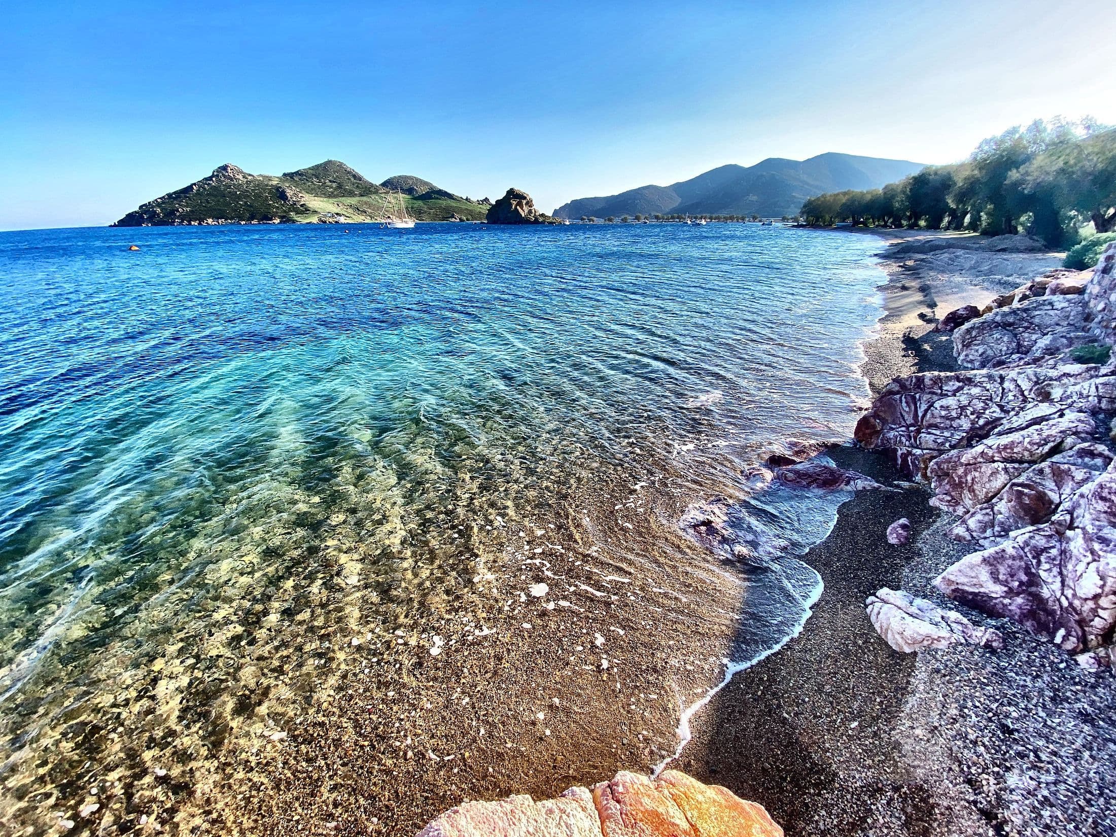 Pink rocks at the water’s edge